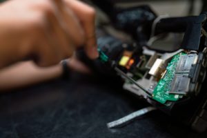 person holding green and black circuit board 300x200