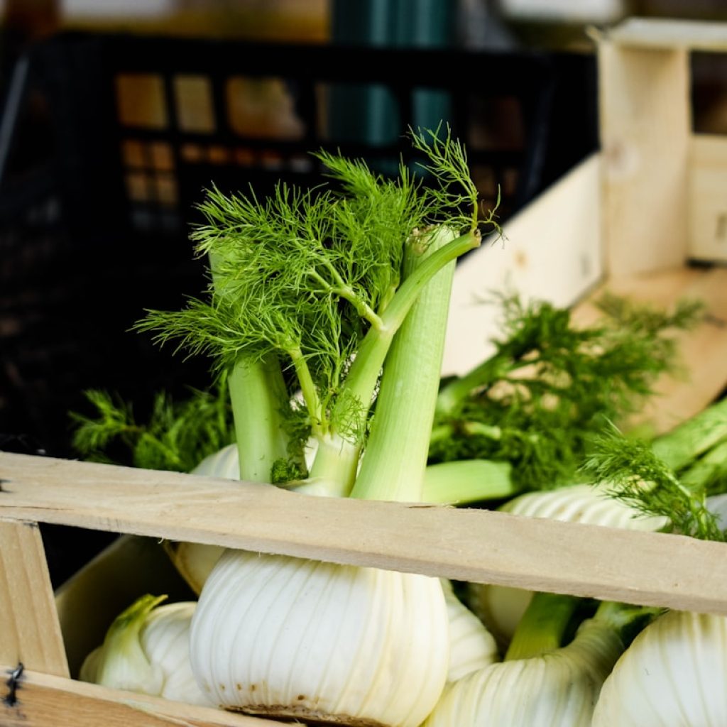 a crate filled with lots of green vegetables