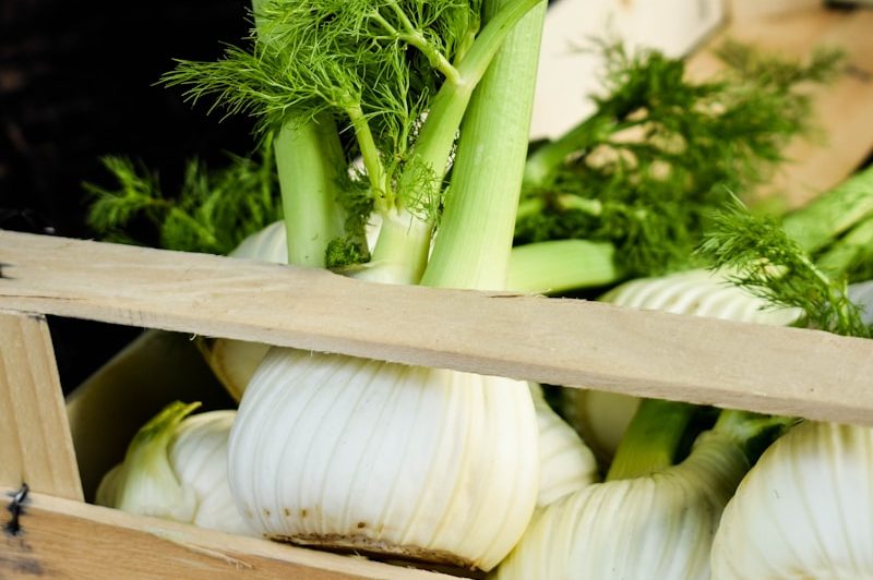 a crate filled with lots of green vegetables