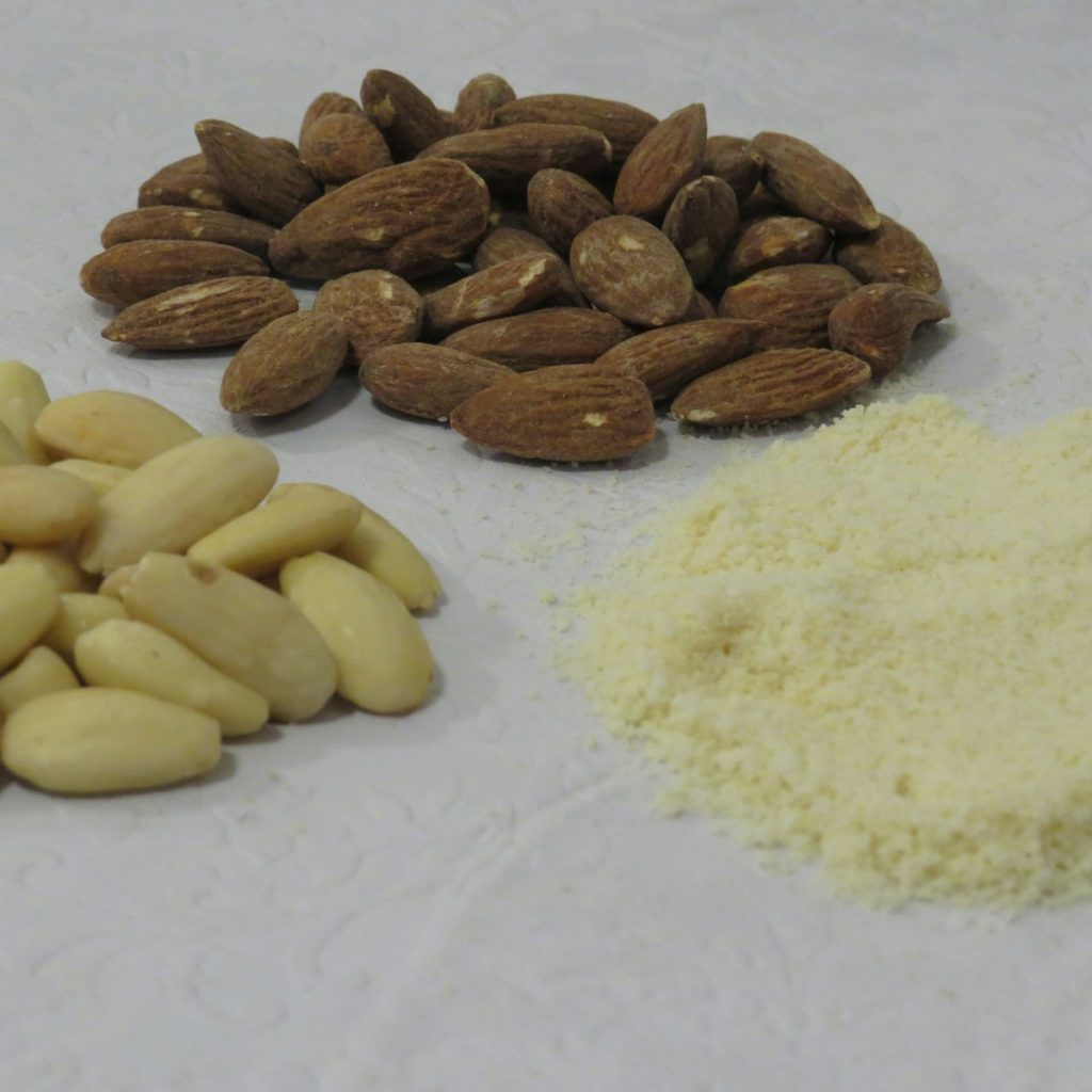 a pile of nuts next to a pile of rice