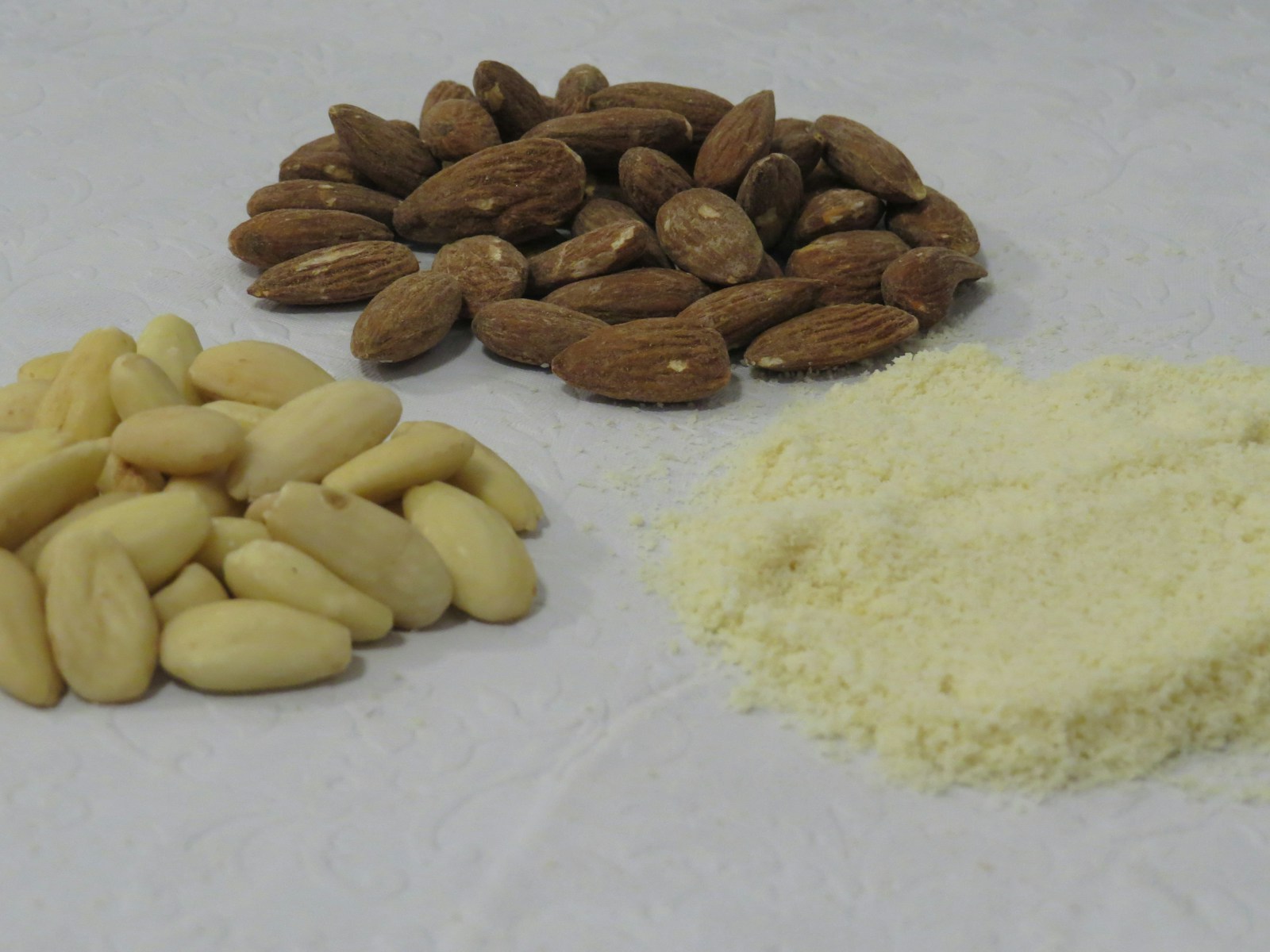 a pile of nuts next to a pile of rice