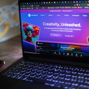 A laptop shows a website about ai creativity.